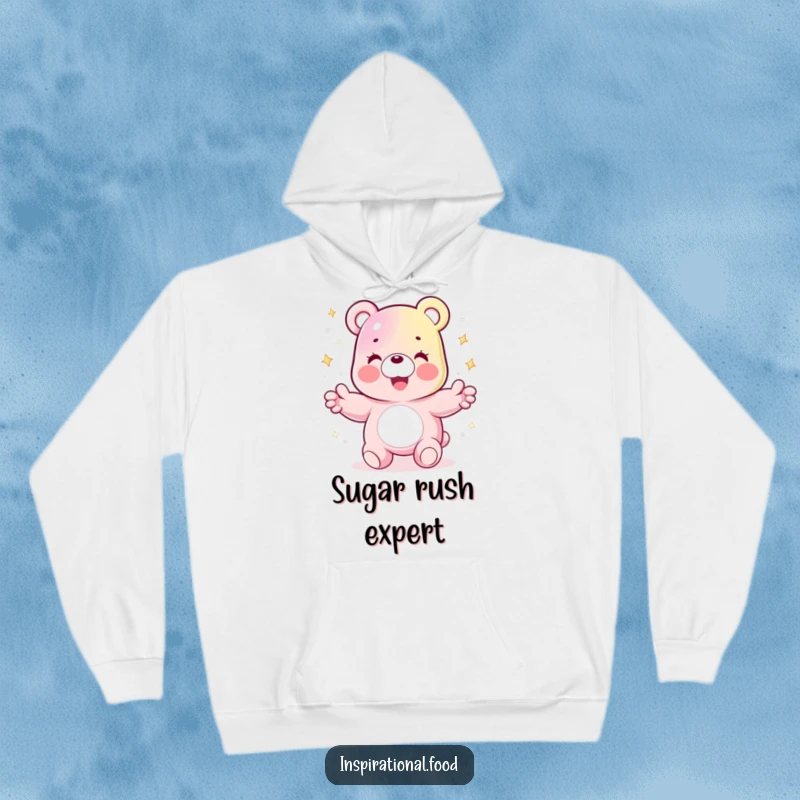 Funny hoodie showing a joyful gummy bear character juggling sparkling sugar crystals, providing warmth and a sweet chuckle.